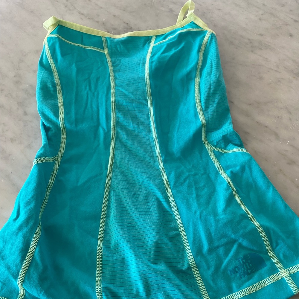 The North Face turquoise running top with built in bra, women’s sz XS